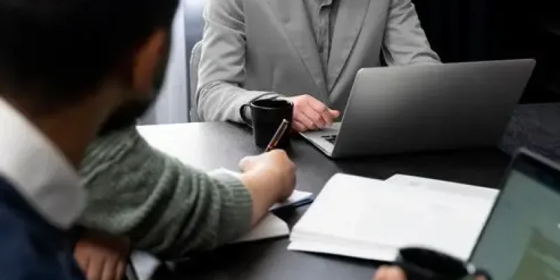 trans-person-working-office-with-colleagues_23-2149286968
